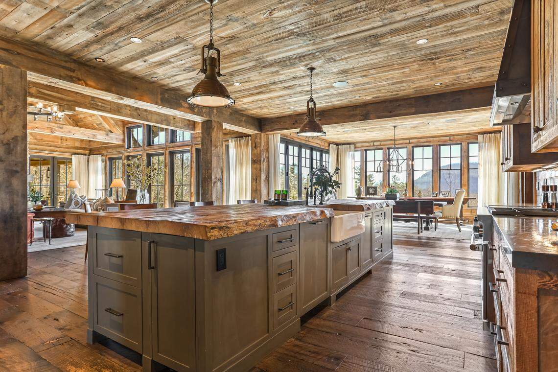 The expansive kitchen and dining areas, along with adjoining covered and open stone patios, complete with a fireplace are perfect for entertaining.