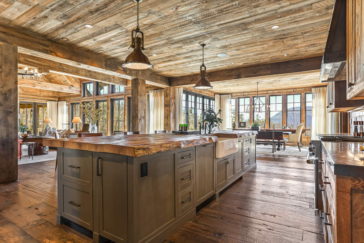The expansive kitchen and dining areas, along with adjoining covered and open stone patios, complete with a fireplace are perfect for entertaining.