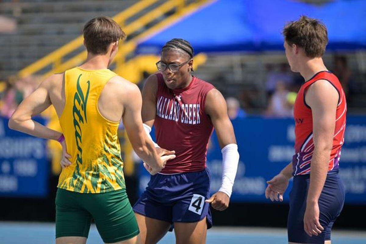 Mallard Creek’s Nyan Brown congratulates a competitor after winning the 300-meter hurdles state title Saturday in Greensboro, North Carolina.