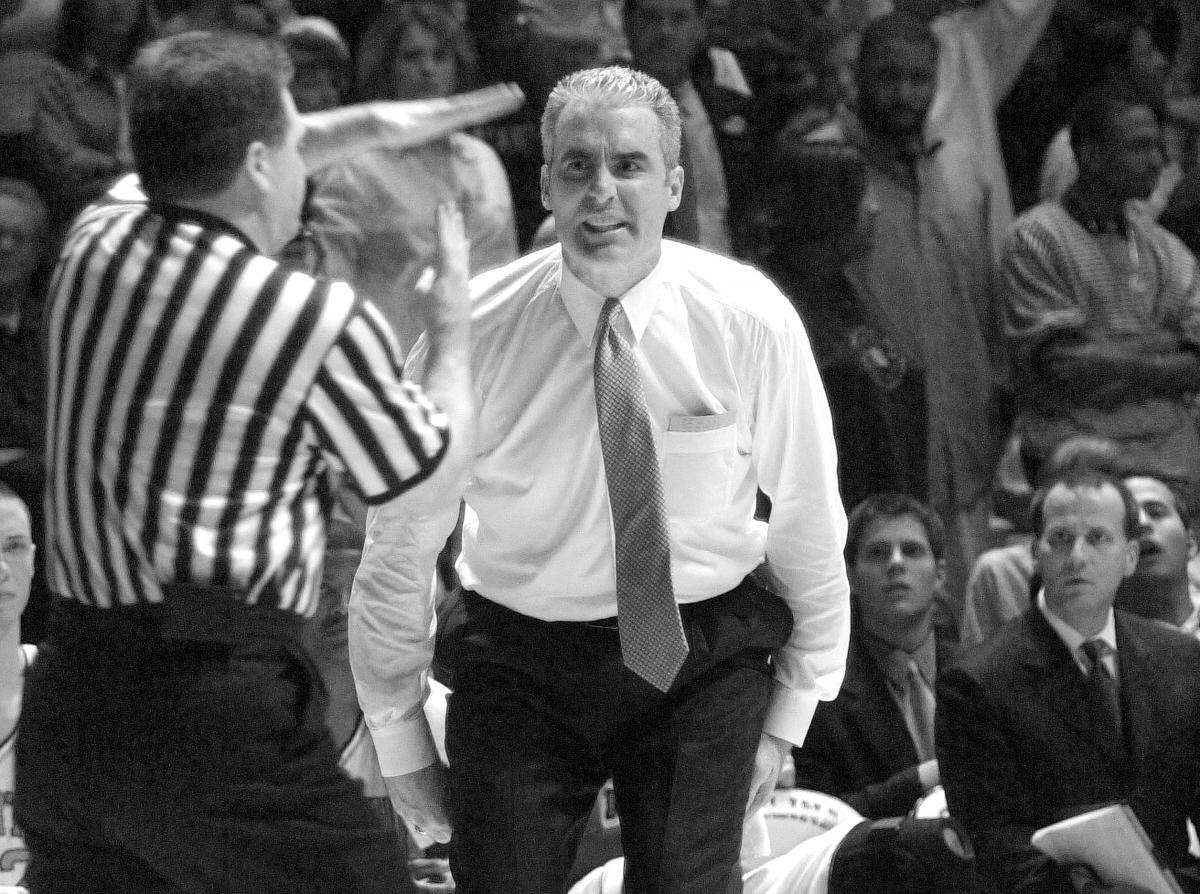 An official calls a technical foul on UNC coach Matt Doherty in 2001.