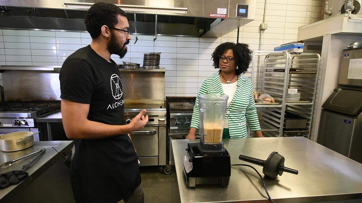 Chef Ken Aponte of Alchemy at C-3 Lab talks to CharlotteFive reporter Emiene Wright about his vegan tostones in April 2021. Aponte and Wright were filming the new CharlotteFive mini series, “The Skillet: How Black Cuisine Became America’s Supper.”
