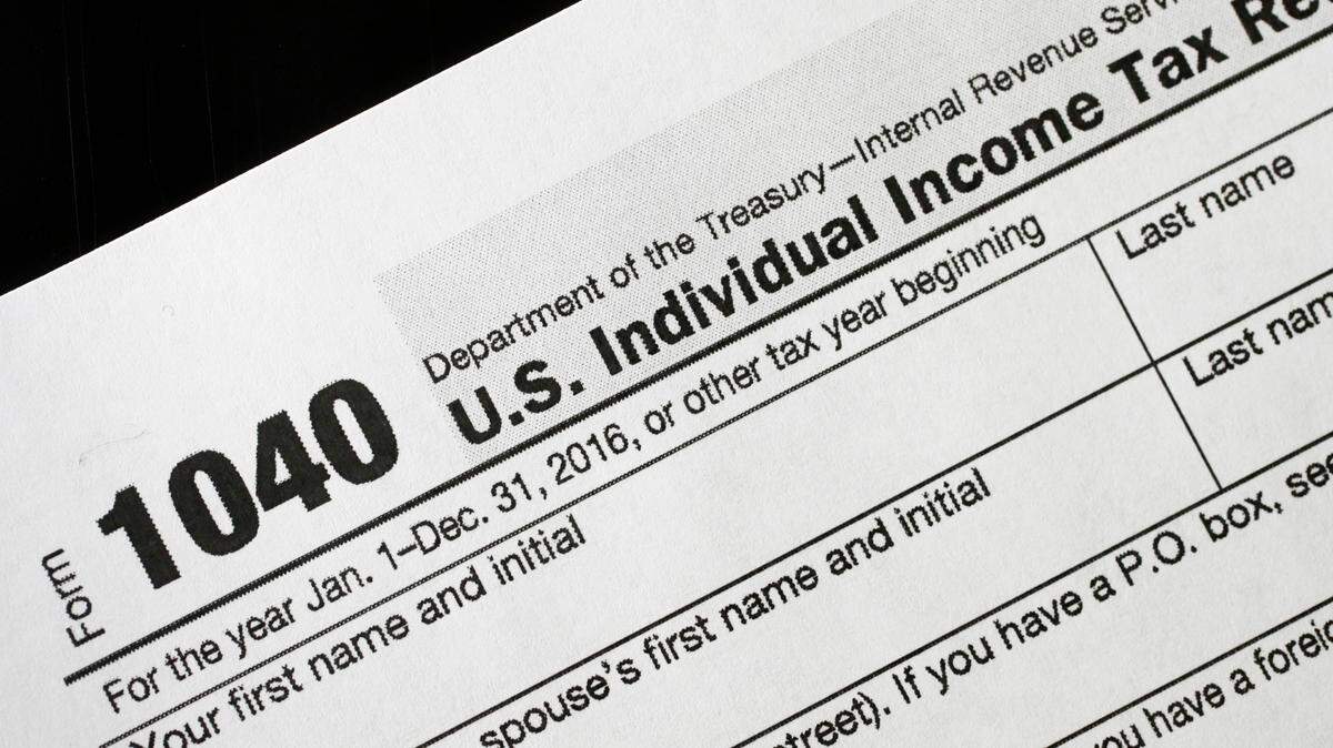 A 1040 tax form appears on display, Tuesday, Jan. 10, 2017, in New York. (AP Photo/Mark Lennihan)