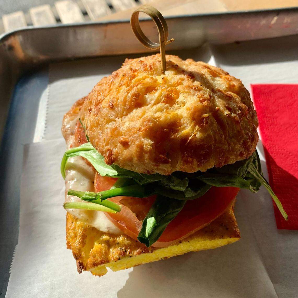 Egg, provolone, spinach and roast tomato sandwich on a cheddar biscuit at Sunflour Baking Co.