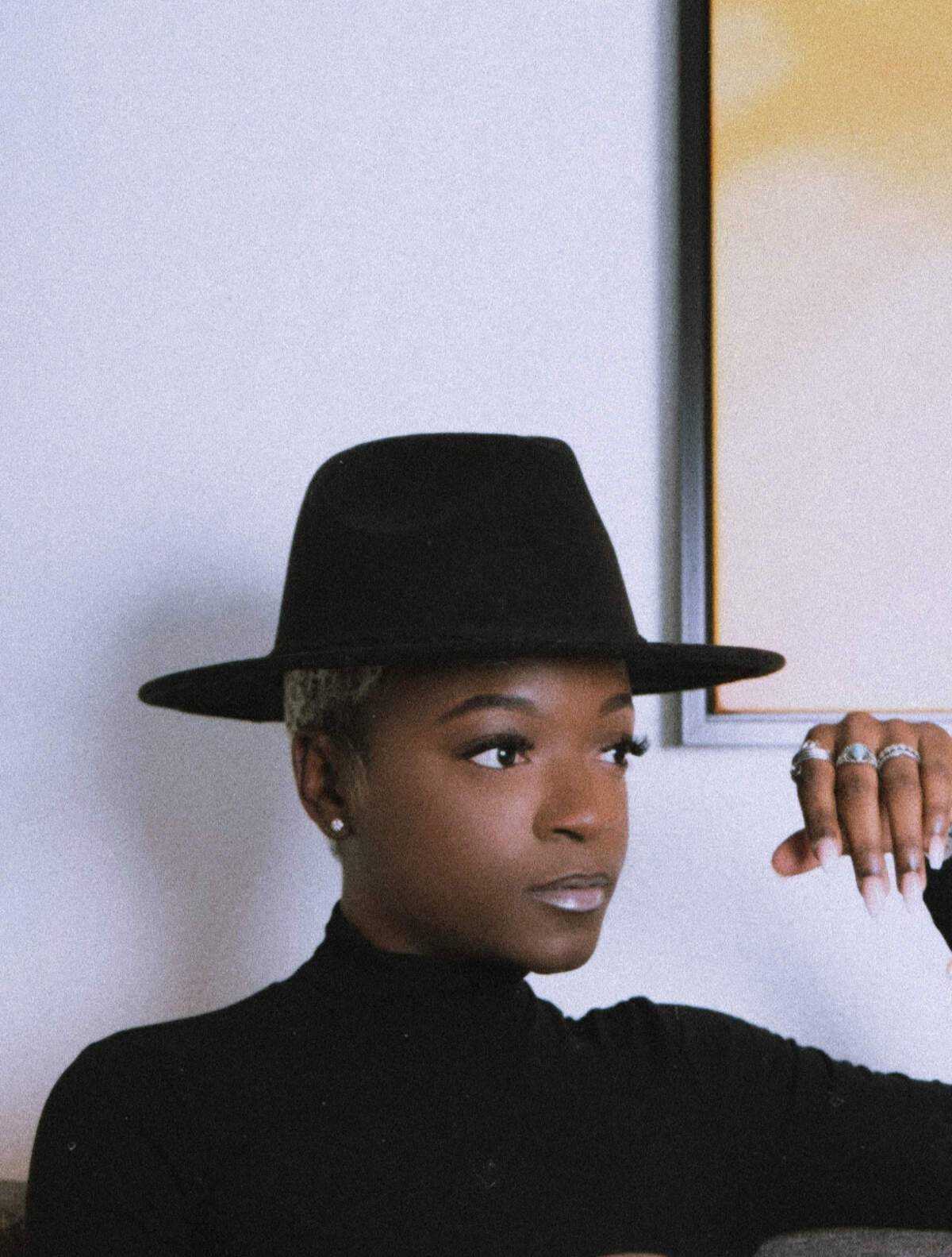 Charlotte-based fashion designer MENIA PAIGE poses for a portrait in a in black hat. Destiny Paige Reeves, aka, MENIA will present her version of Black dandyism during the “Superfine at the Gantt: Exploring Black Dandyism.” The event is an evening long program, with a red carpet, fashion show and panel taking place Friday, May 2, 2025 at the Harvey B. Gantt Center for African American Art & Culture.