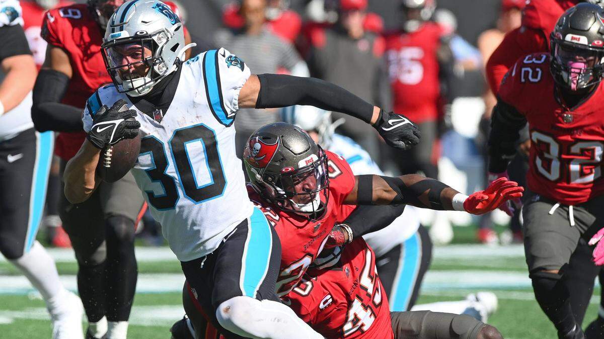Carolina Panthers running back Chuba Hubbard, left, breaks free of the Tampa Bay Buccaneers defense on a touchdown run during second half action at Bank of America Stadium in Charlotte, NC on Sunday, October 23, 2022. The Panthers defeated the Buccaneers 21-3.