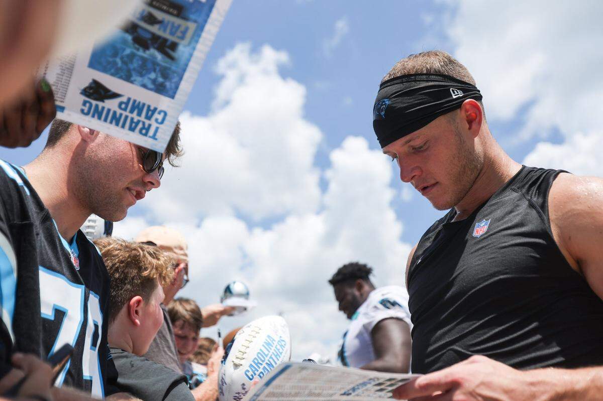 Panthers running back Christian McCaffrey signs autographs for fans after training camp practice at Wofford College on Tuesday, August 9, 2022 in Spartanburg, SC.