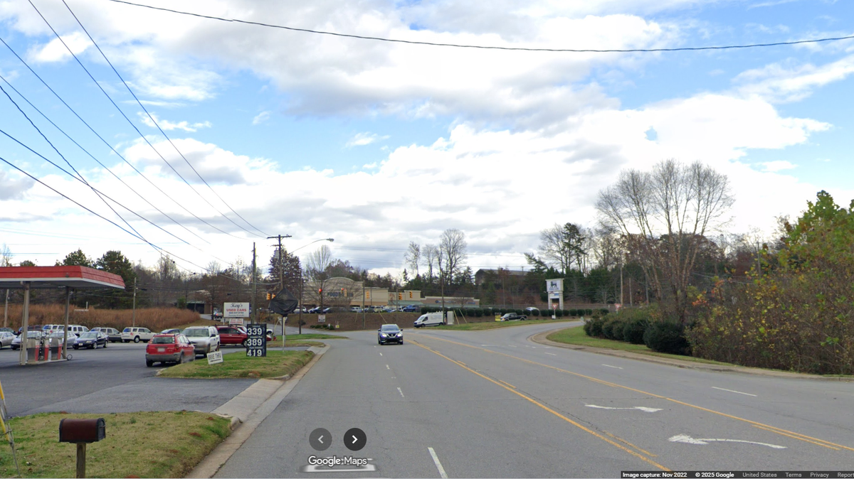 The lawnmower was being driven in the dark near this busy intersection in Morganton, North Carolina, police say.  
