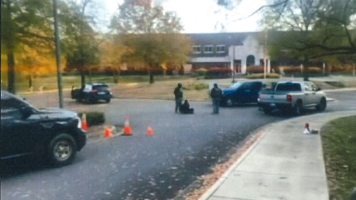 This screenshot from a court video shows a protester being arrested Nov. 16 outside the U.S. Department of Homeland Security office in Charlotte. 