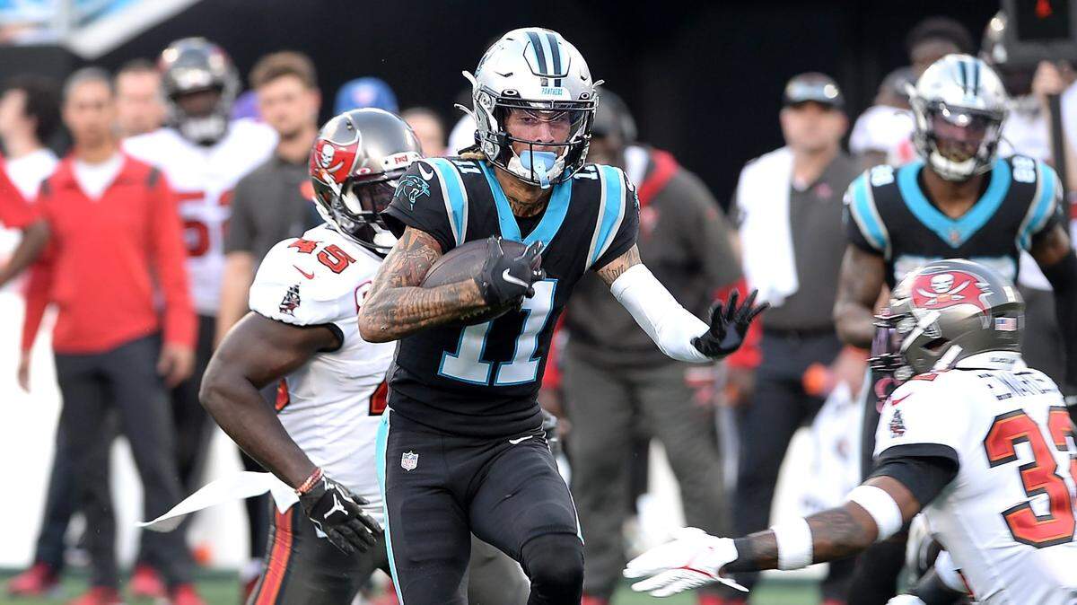 Carolina Panthers wide receiver Robby Anderson, center, picks up yardage following a pass reception against the Tampa Bay Buccaneers during fourth quarter action on Sunday, December 26, 2021 at Bank of America Stadium in Charlotte, NC. The Buccaneers defeated the Panthers 32-6.