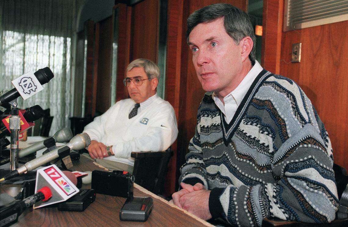 Mack Brown ponders the answer to a question as he announced his resignation as coach of the UNC football team in 1997. At left is Dick Baddour, atheletic director for the Tar Heels.