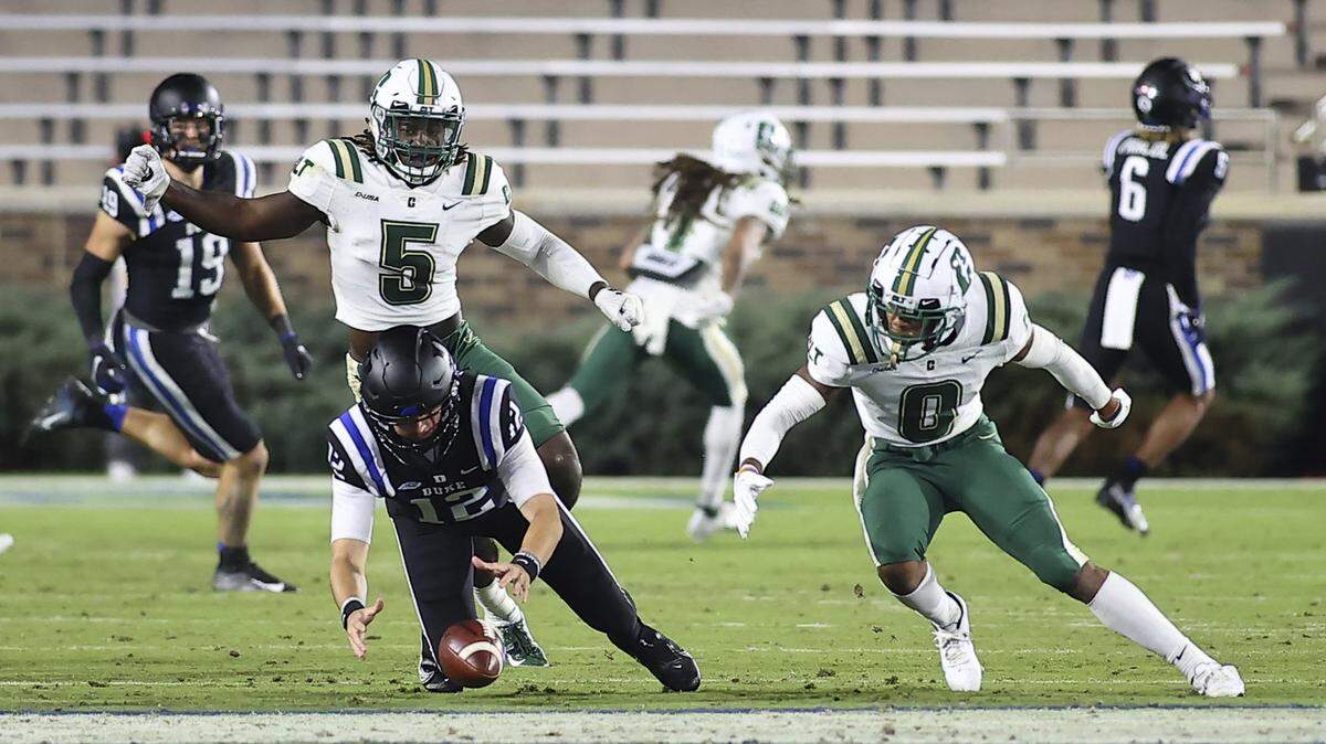 Duke quarterback Gunnar Holmberg (12) and Charlotte 49ers defensive back Antone Williams (0) reach for a fumble during their game Oct. 31 in Durham. That was the last time Charlotte played. Their game against WKU on Tuesday has been canceled.