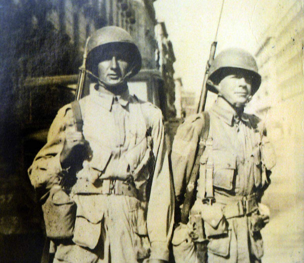 Paratroopers of H Company 505th Parachute Infantry Regiment of the 82nd Airborne Division, S/Sgt. John J. Sabo, left, and Corporal Harold Eatman patrol the streets of Naples, Italy Oct. 1943. Eatman was 28 when he jumped into Normandy, France, hours before the D-Day. He was a member of the 82nd Airborne and would make all four major World War II jumps.