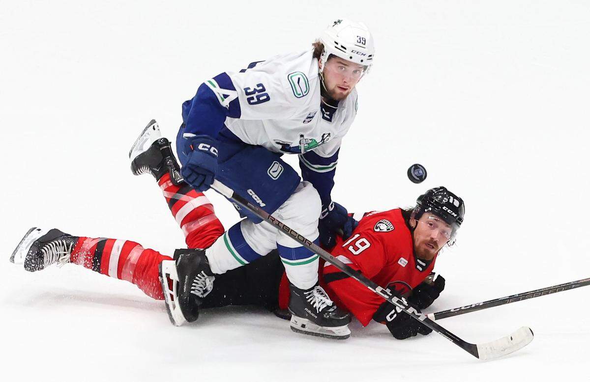 Charlotte Checkers John Leonard and Canucks Ty Mueller collide during the Calder Cup on Sunday, June 15, 2025 at Bojangles Coliseum in Charlotte. The Checkers defeated the Canucks 3-2, tying the series 1-1.