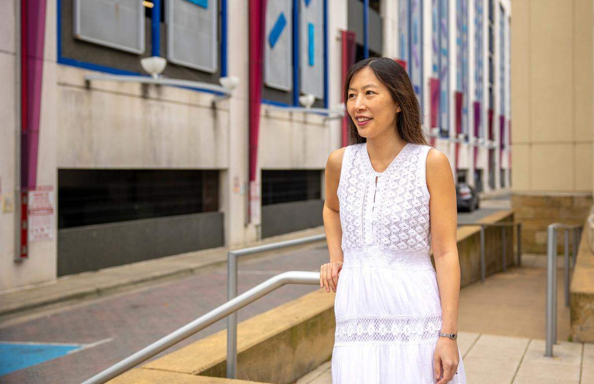 Jinna Kim, shown in front of the Levine Museum of the New South in Charlotte, has spent almost a decade acting in Charlotte after starting as a background extra in the series “Homeland.” Kim has also directed her own film, but her main profession is writing patents for Bank of America.