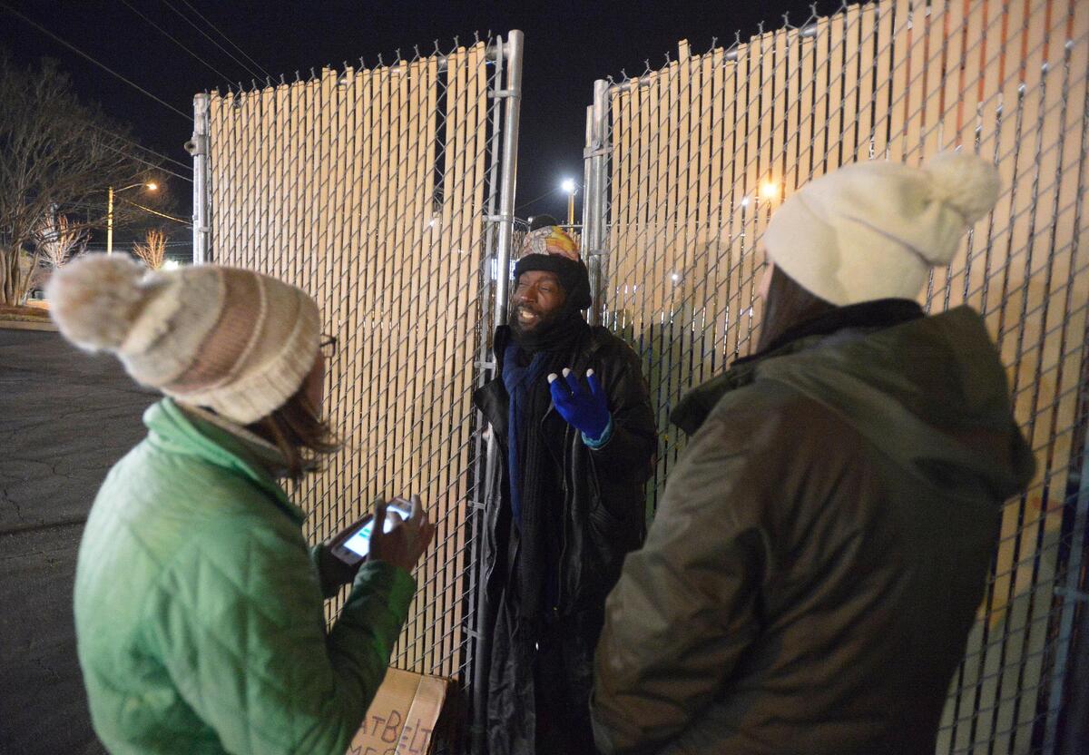 A homeless man met and asked questions at the dumpster area where he is living by volunteers Katy Harrell and Laura Covian. He is living in this dumpster area. Volunteers in small groups will headed out on the streets before dawn Thursday to count the number of homeless people in Mecklenburg County.