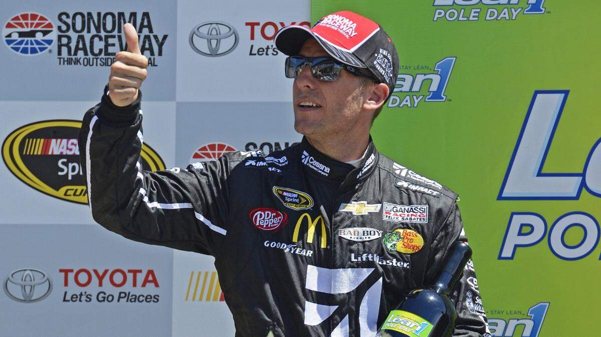 Retired NASCAR driver Jamie McMurray gives the thumbs up winning the pole position during qualifying for the Toyota/Save Mart 350 at Sonoma Raceway in 2014. McMurray will drive for Spire Motorsports in the 2021 Daytona 500.