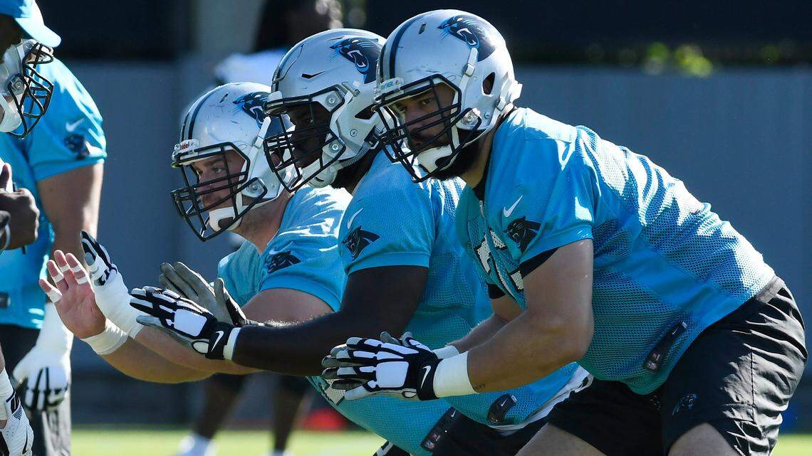 Carolina Panthers offensive linemen Tyler Larsen (left) and Taylor Moton (center) are among the group competing to start at left guard alongside offensive tackle Matt Kalil (right).