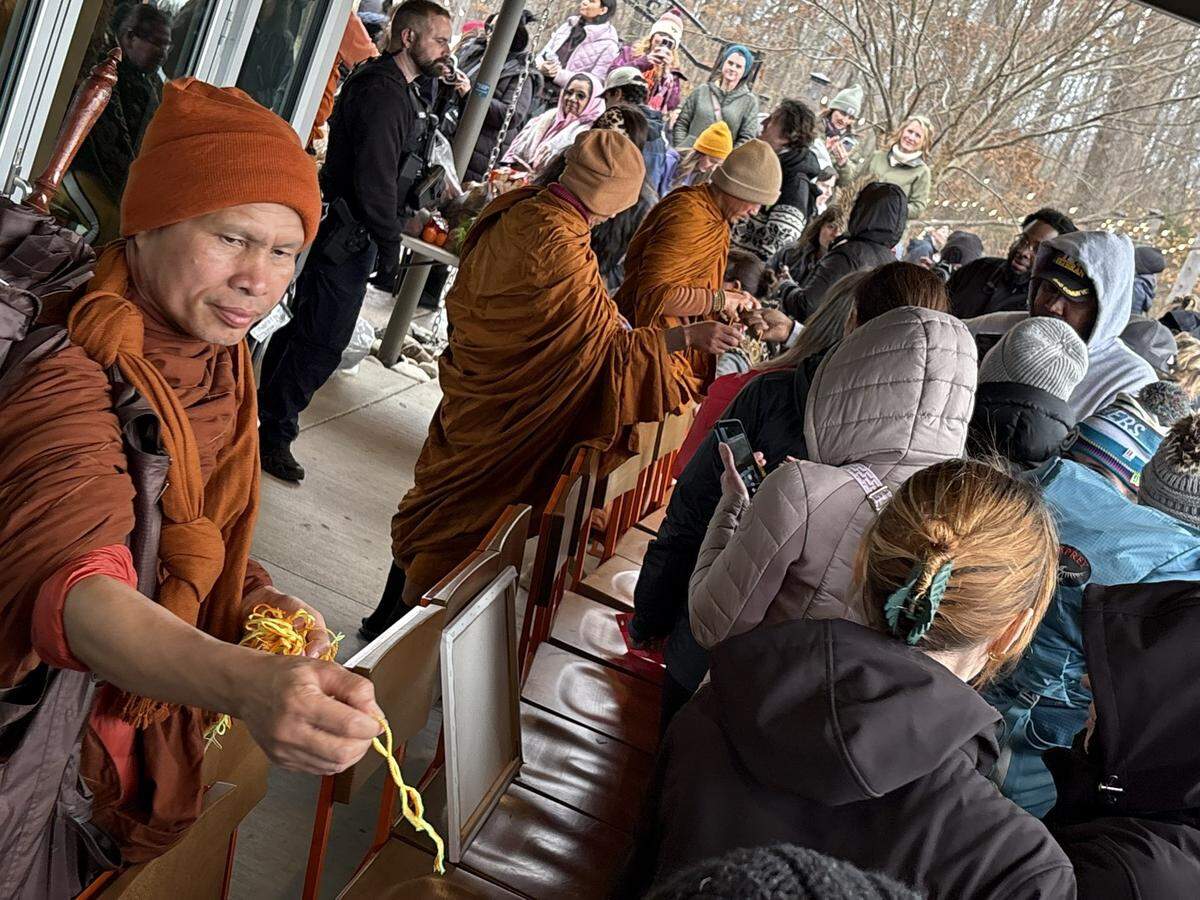 Monks who have traveled on foot starting in Dallas, TX made a stop in Anne Springs Close Greenway in Fort Mill, SC during their walk for peace on Wednesday, January 14, 2026. Here, several monks give out string bracelets as blessings to visitors.