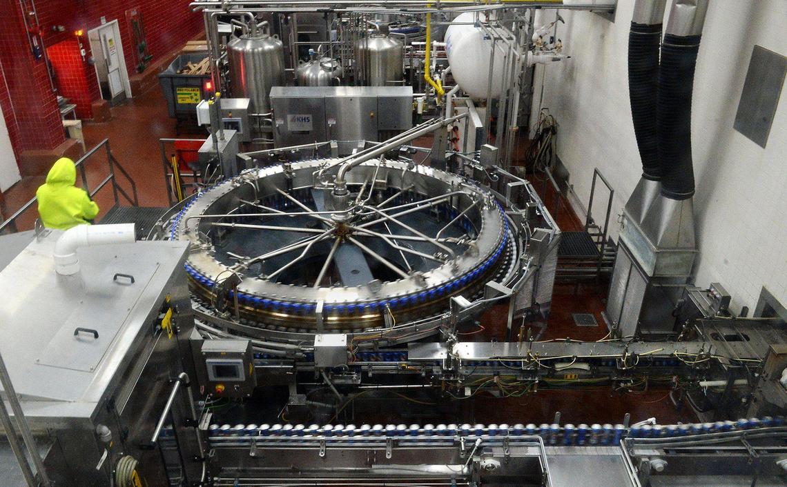 Beverage containers rapidly stream one after another in the canning department of Coke Consolidated Snyder Production Center.