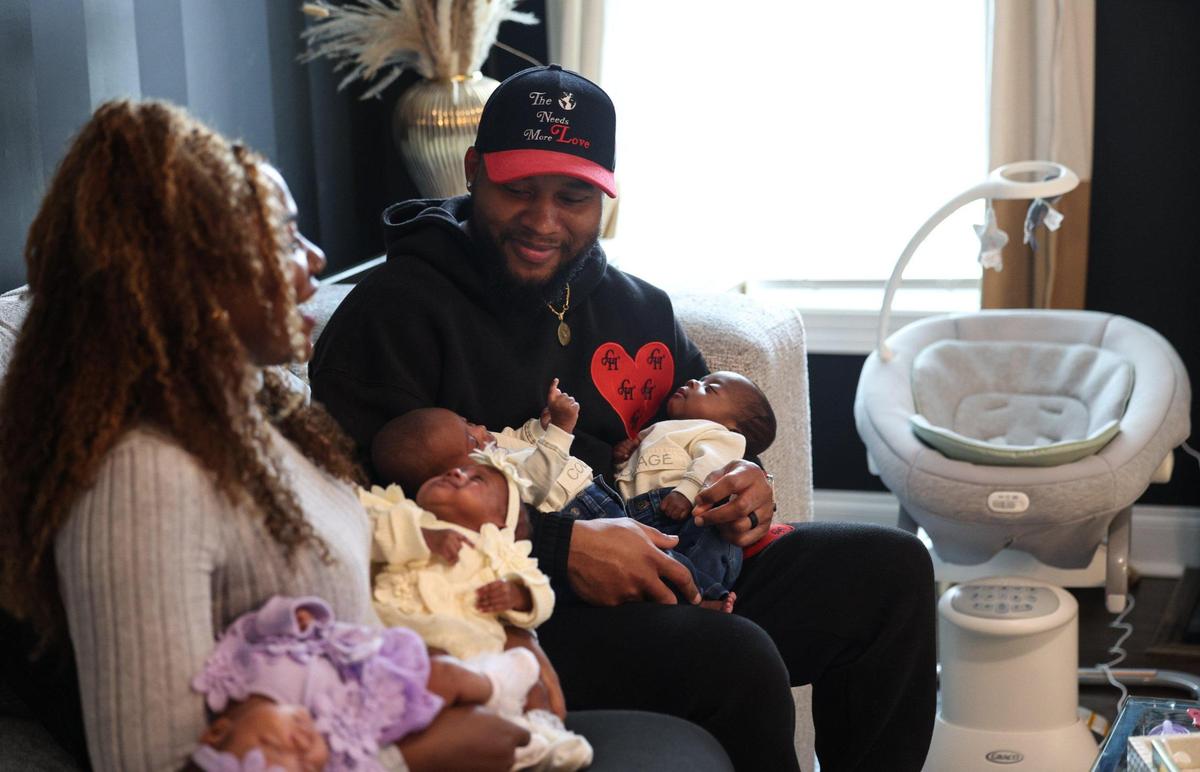 Ronjera Abrahams holds her daughters Ariyah and Aniyah, while husband Carlos holds their sons, Cayden and Carter. Ronjera gave birth to the quadruplets on Dec. 2. “Sometimes it don’t feel real,” she says. “We’ll just stare at them, all the time. I’m just like, ‘Did I really have four babies??’”