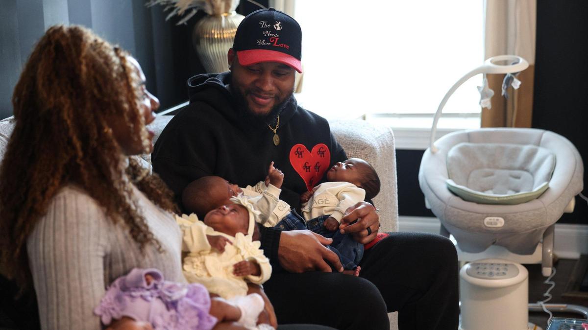 Ronjera Abrahams holds her daughters Ariyah and Aniyah, while her husband Carlos holds their sons, Cayden and Carter. Ronjera gave birth to the quadruplets on Dec. 2. “Sometimes it don’t feel real,” she says. “We’ll just stare at them, all the time. I’m just like, ‘Did I really have four babies??’”