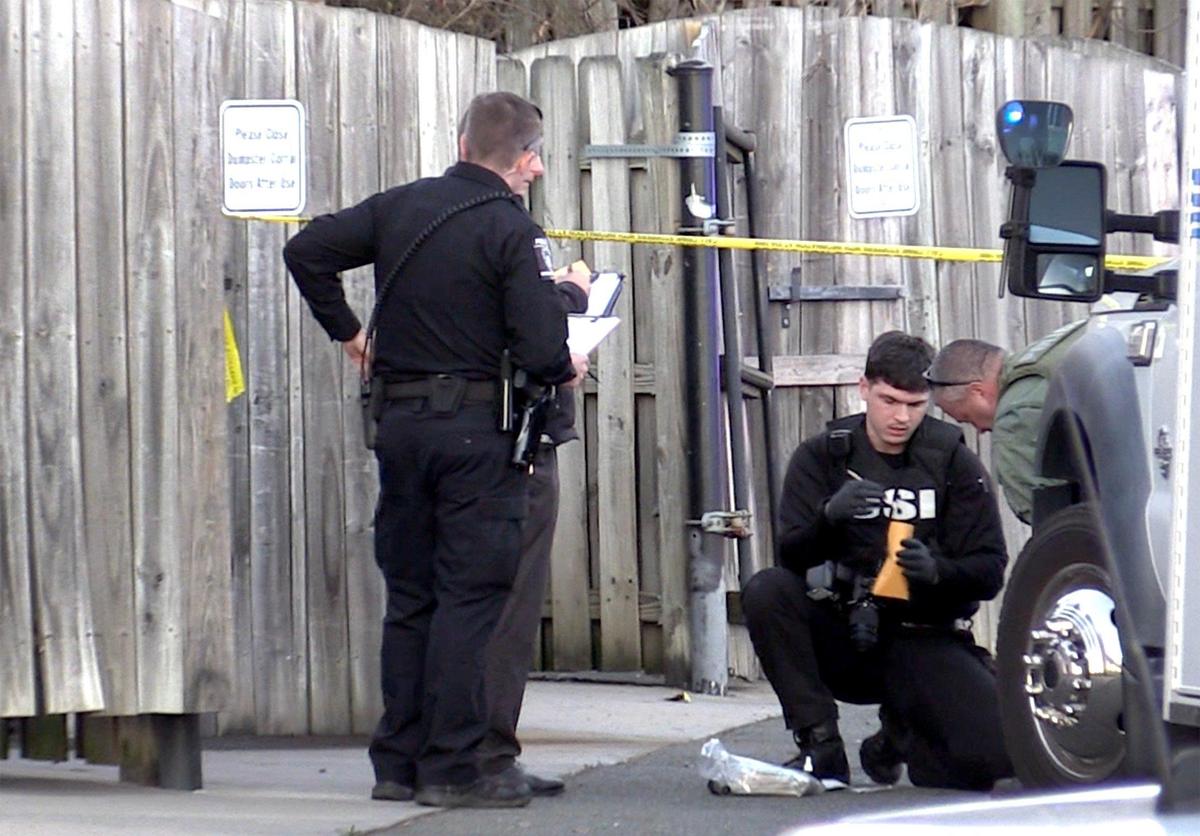 Crime scene investigators collect evidence after a fatal shooting by a police officer.