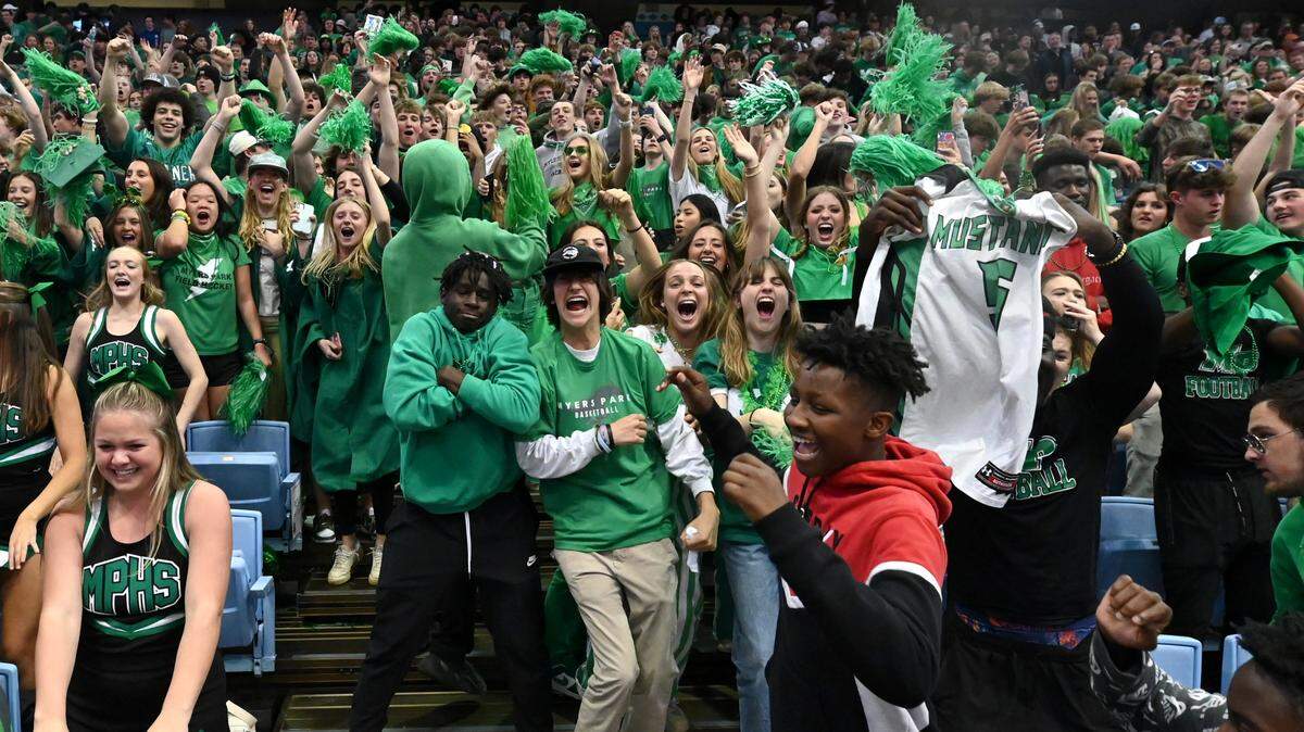 Myers Park students celebrate the boys basketball teams 74-60 victory over Richmond Senior in the NCHSAA state 4A championship game at the Dean Smith Center on Saturday, March 11, 2023.