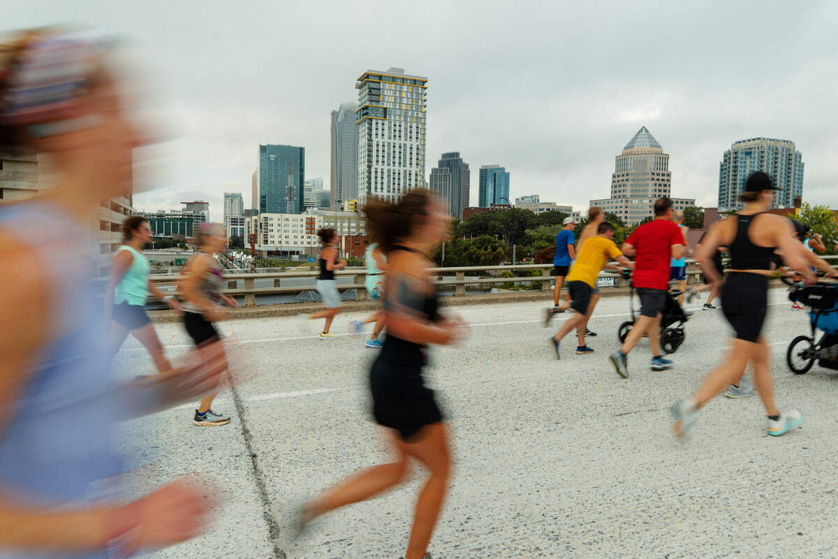 Runners dash past uptown Charlotte in the 2022 Around the Crown 10K.