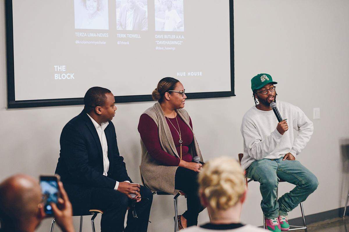 David J. Butler, right, speaks during an event for Hue House, which he co-founded.