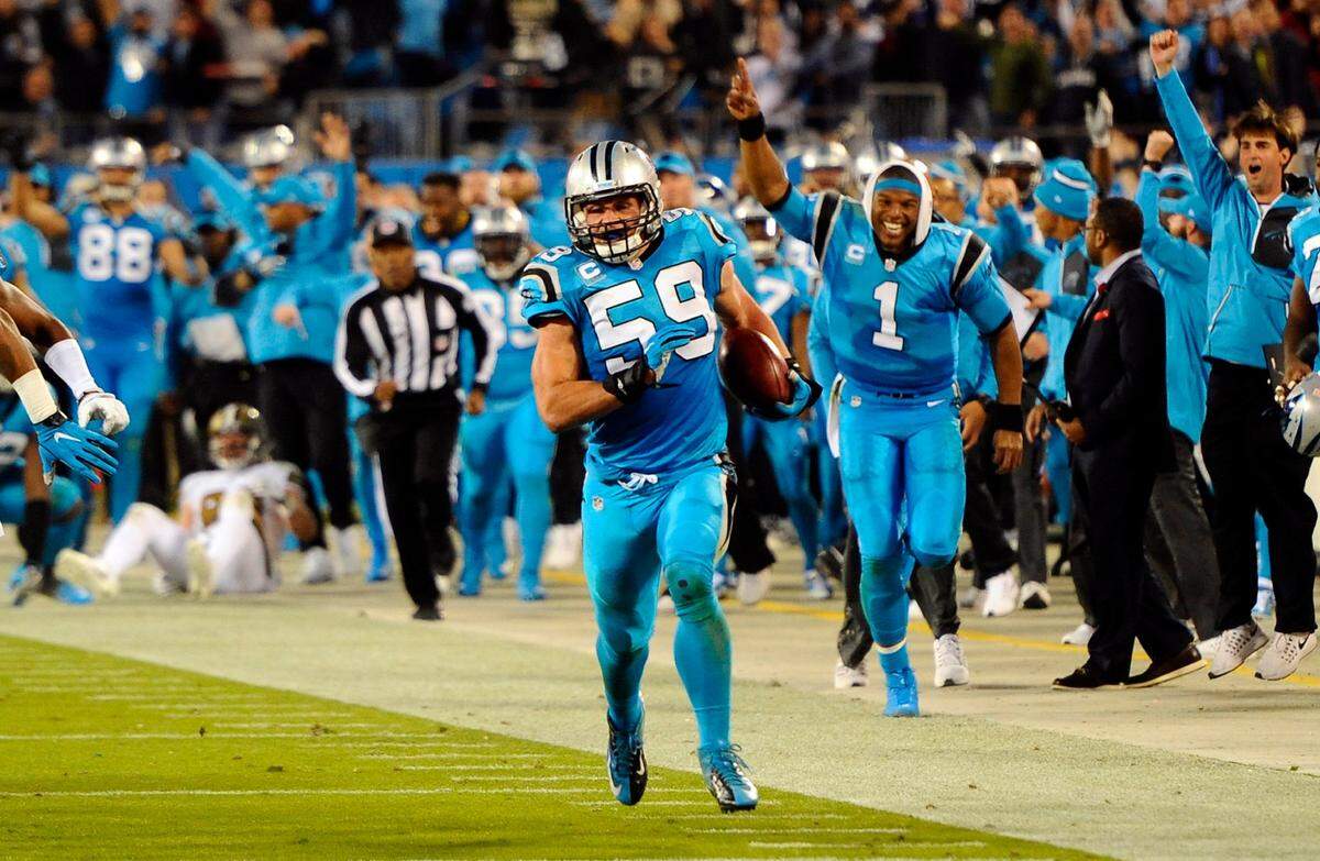 Carolina Panthers middle linebacker Luke Kuechly (59) returns the ball after a blocked New Orleans Saints field goal attempt in the second quarter at Bank of America Stadium on November 17, 2016, as Cam Newton (1) cheers in the background. 