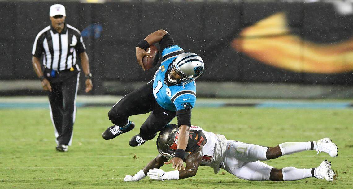 Carolina Panthers quarterback Cam Newton (1) tries to stretch for a first-down past Tampa Bay Buccaneers free safety Jordan Whitehead (31) in the first quarter at Bank of America Stadium in Charlotte, NC on Thursday, September 12, 2019. The Bucs won 20-14.