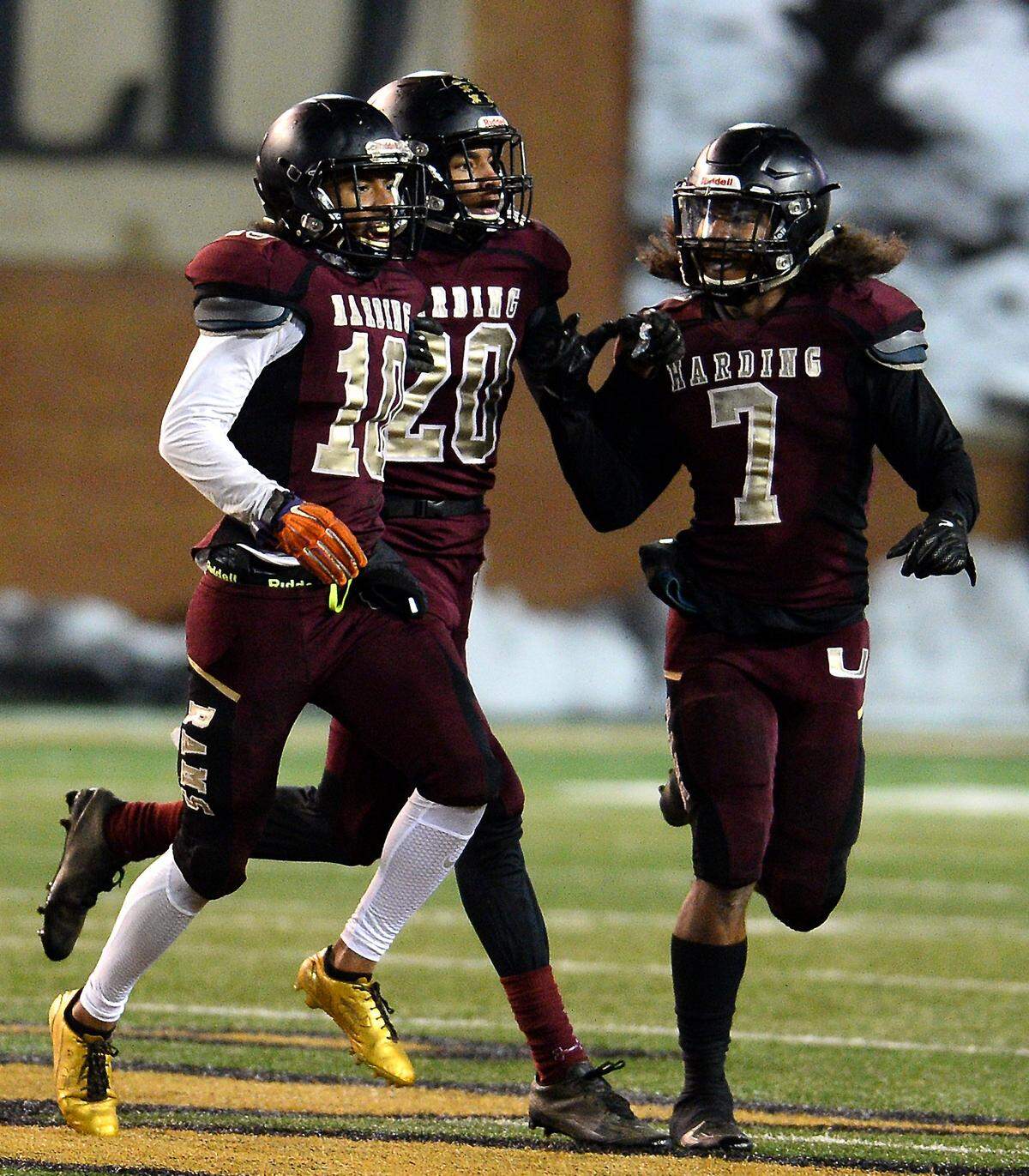 Harding cornerback Trayvon Corbett, left, is congratulated by teammates Marquise Nelson, center, and Martin Delgado after Corbett intercepted a Scotland County pass during the NCHSAA 4A State Championship game at BB&T Field in Winston-Salem, North Carolina, on Dec. 9, 2017. Harding defeated Scotland County 30-22.
