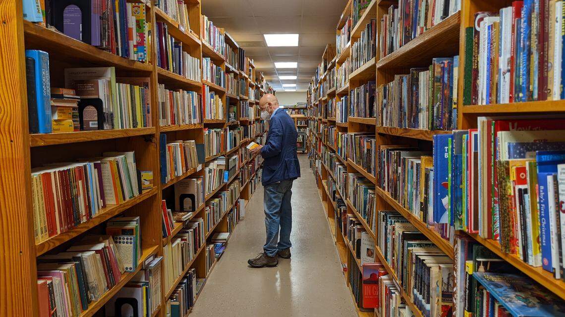 Philip Petty peruses the aisles at Book Buyers on Wednesday at the used book store’s new Eastway Crossing shopping center location.