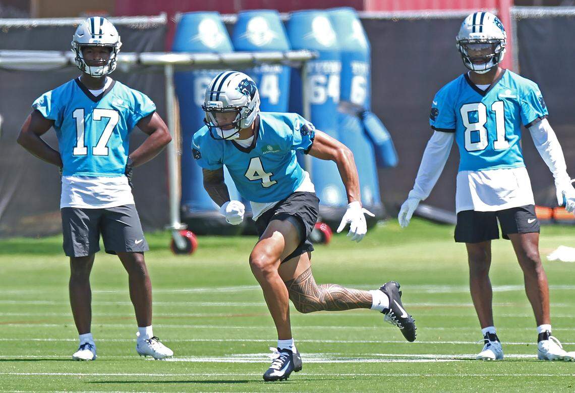 Carolina Panthers rookie wide receiver Tetairoa McMillan, center, breaks off the line as wide receivers Sevonne Rhea, left and Moose Muhammad III, right, look on during the the team’s rookie minicamp practice on Friday, May 9, 2025.