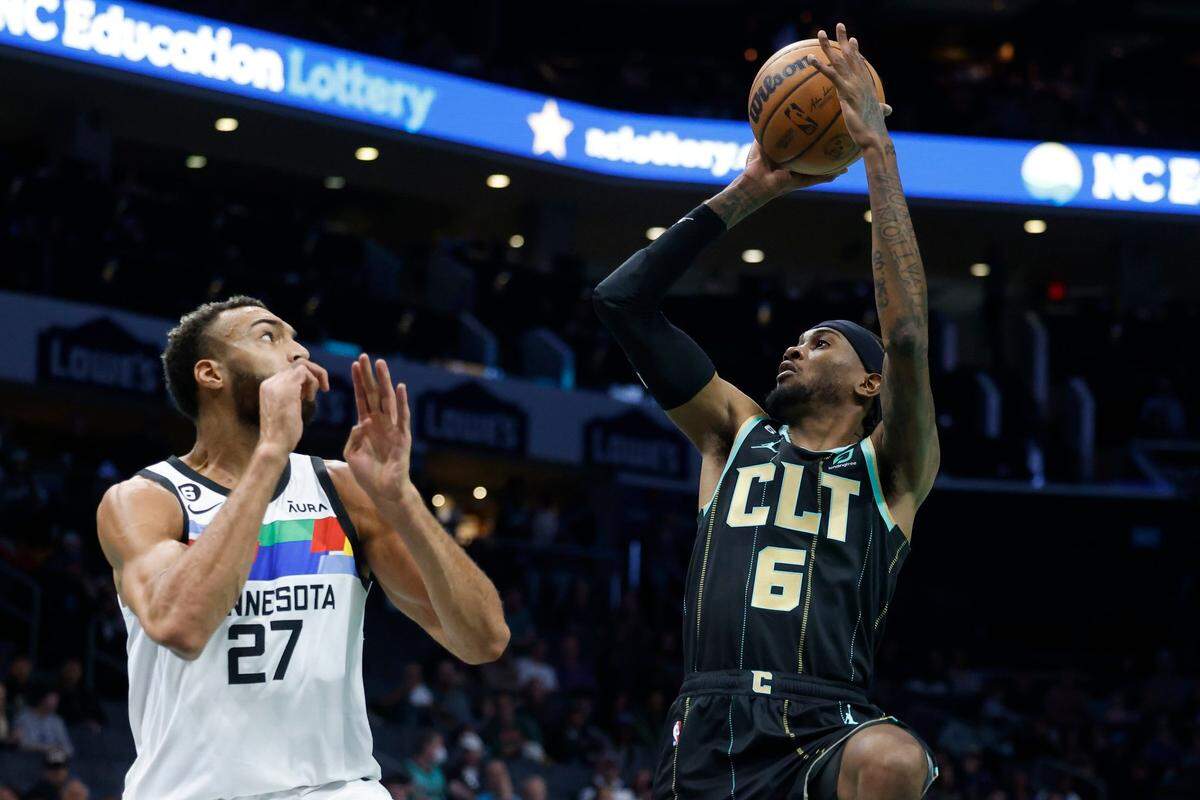 Charlotte Hornets forward Jalen McDaniels (6) shoots over Minnesota Timberwolves center Rudy Gobert (27) during a game at Spectrum Center in Charlotte, N.C., Friday, Nov. 25, 2022.