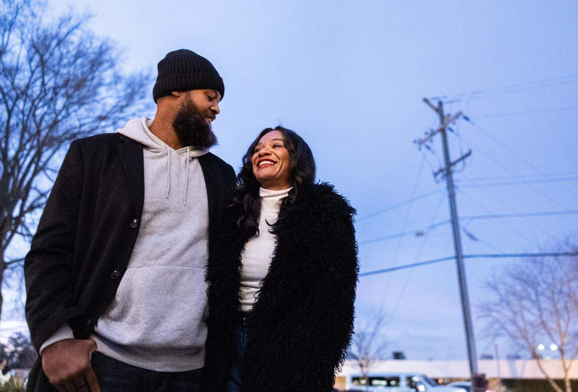 Andre Procope and his wife, Nakisha, share a laugh during the Tall Tour event at Brewers At 4001 Yancey in Charlotte, N.C., on Saturday, December 6, 2025. Andre is 6-foot-10 inches and his wife is 6 feet tall.