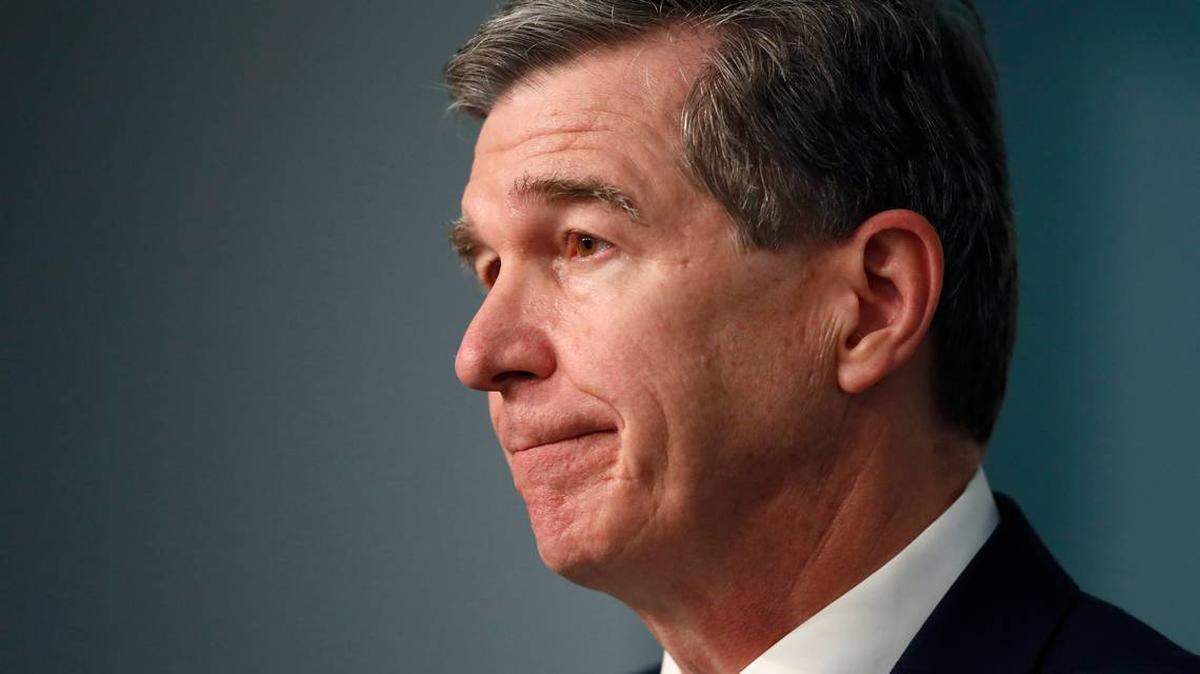Gov. Roy Cooper listens to a question during a briefing in Raleigh. On July 14, Cooper announced guidelines that allow K-12 schools to reopen at reduced in-classroom capacity. The plan allows school districts to decide whether to offer online only instruction. 