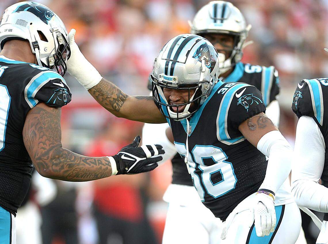 Carolina Panthers safety Myles Hartsfield, right, is congratulated by his teammates after sacking Tampa Bay Buccaneers quarterback Tom Brady during first quarter action at Raymond James Stadium in Tampa, Fl. on Sunday, January 9, 2022.