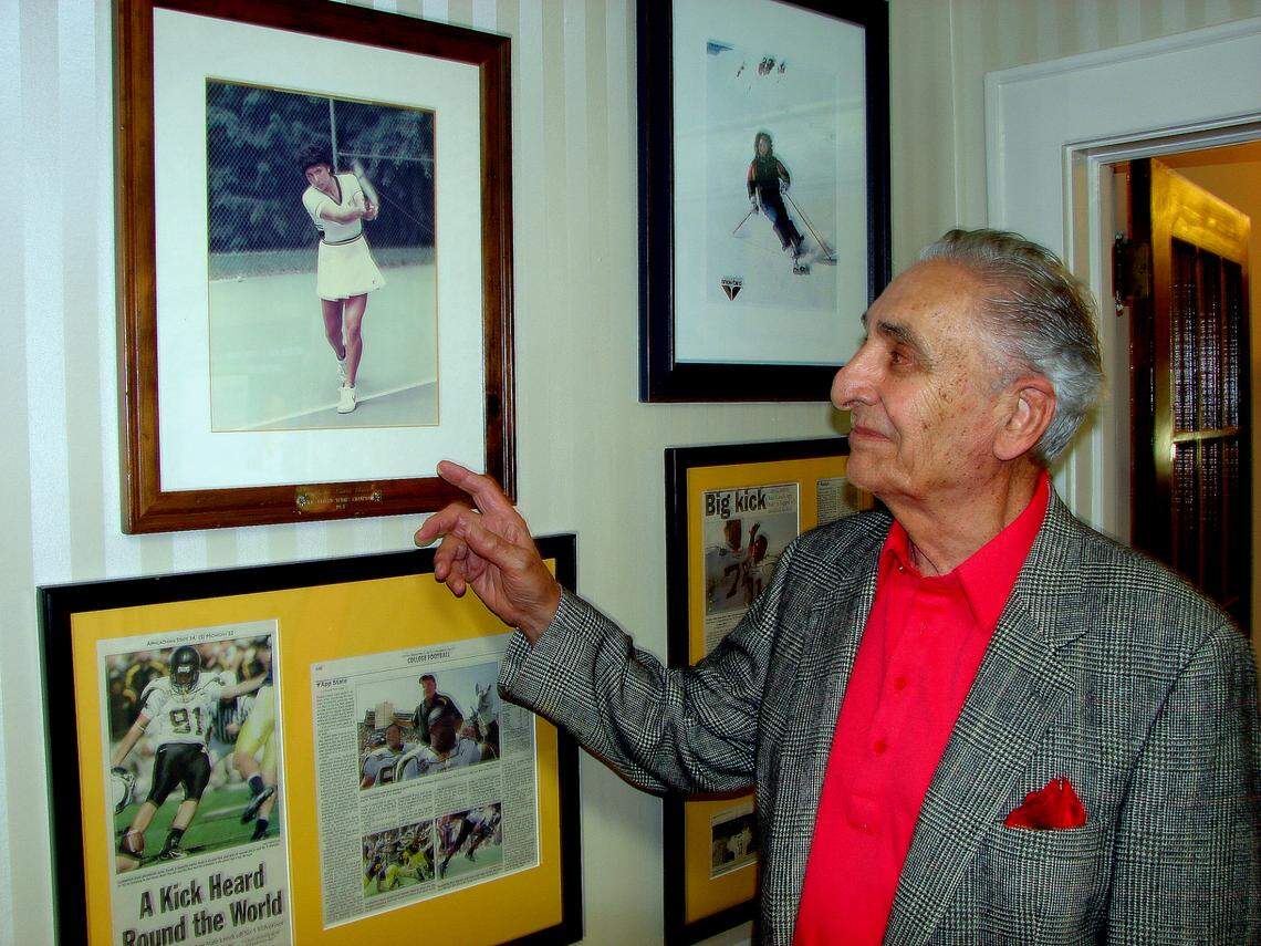 Marshall Rauch displays photos of his family in his Gastonia office in this 2013 file photo.