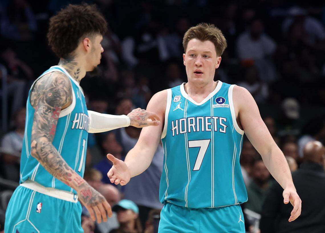 Charlotte Hornets guard LaMelo Ball, left, congratulates guard/forward Kon Knueppel following Knueppel’s 3-point basket against the Brooklyn Nets on Wednesday at Spectrum Center. The Hornets defeated the Nets, 136-117.