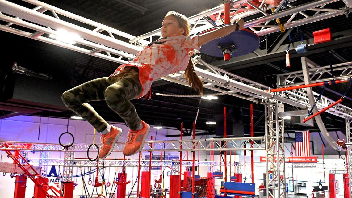 Kinsie Carvin, 10, works her way through a competition course at Ninja Nation in Huntersville.
