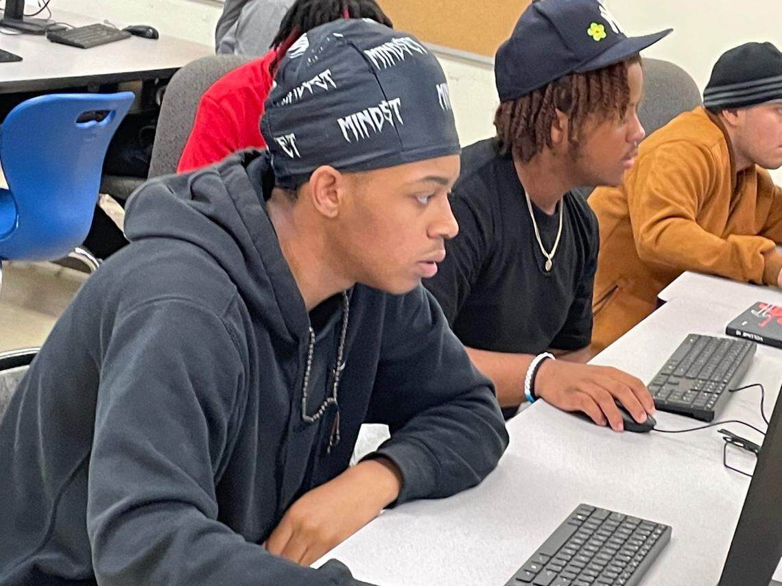 Jonathan Callicoatte (left) and Micah Sherow (center) are students at Phillip O. Berry Academy of Technology on June 1, 2024 who created on a computer 3D virtual models of buildings, including the former McCrorey YMCA, which represented cornerstones in Charlotte’s former Brooklyn neighborhood. The project is a part of a larger effort with Johnson C. Smith University to create a virtual museum of historic Black communities.