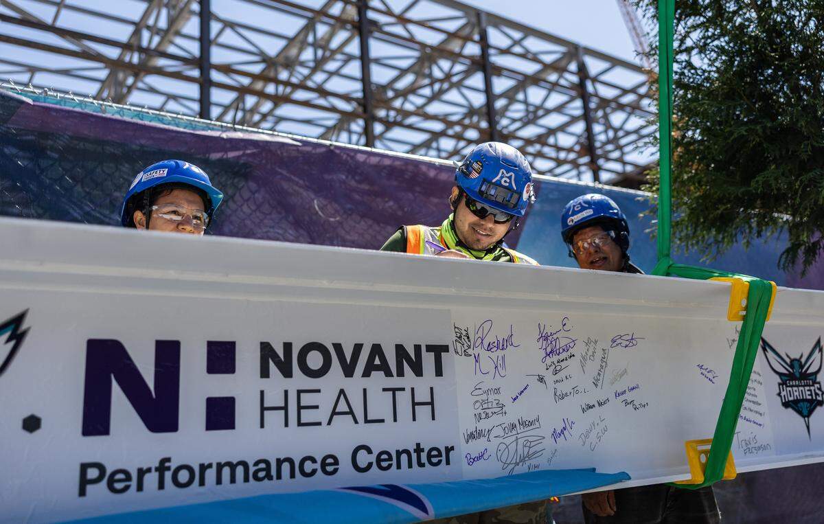 Construction workers sign the beam during the Hornets’ ceremonial Topping Off Ceremony at Novant Health Performance Center’s construction site, celebrating a major milestone, the placement of the building’s final structural beam in Charlotte, N.C., on Monday, May 4, 2026. 