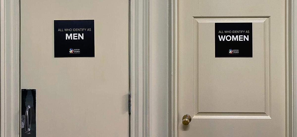 Myers Park Baptist Church has inclusive restroom signs hanging inside the church.