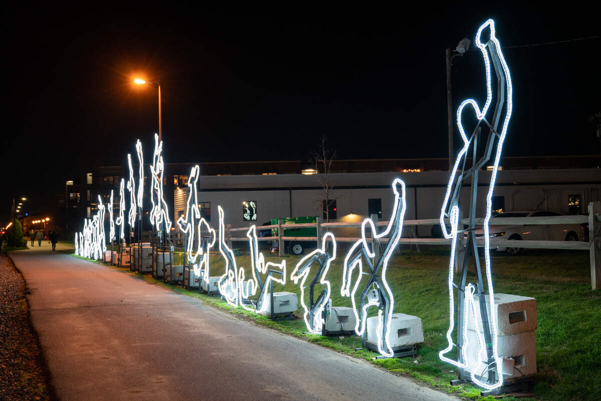 The Run Beyond is a long set of connecting lights with the image of a person running and jumping. It is located just behind Sycamore Brewing on the Rail Trail in South End Charlotte.
