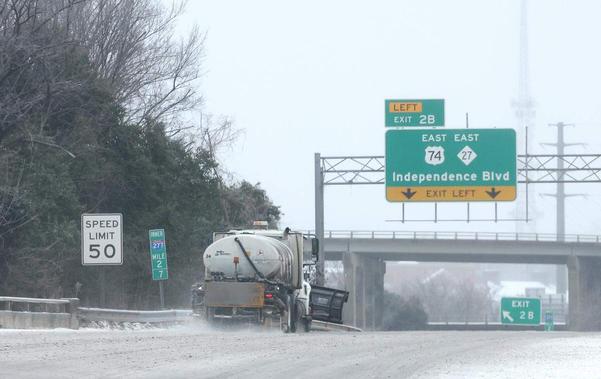 A brine truck travels along the Brookshire Freeway to 74E following a wintry mix of ice, freezing rain and light that arrived in the Charlotte, NC area on Sunday, January 25, 2026.