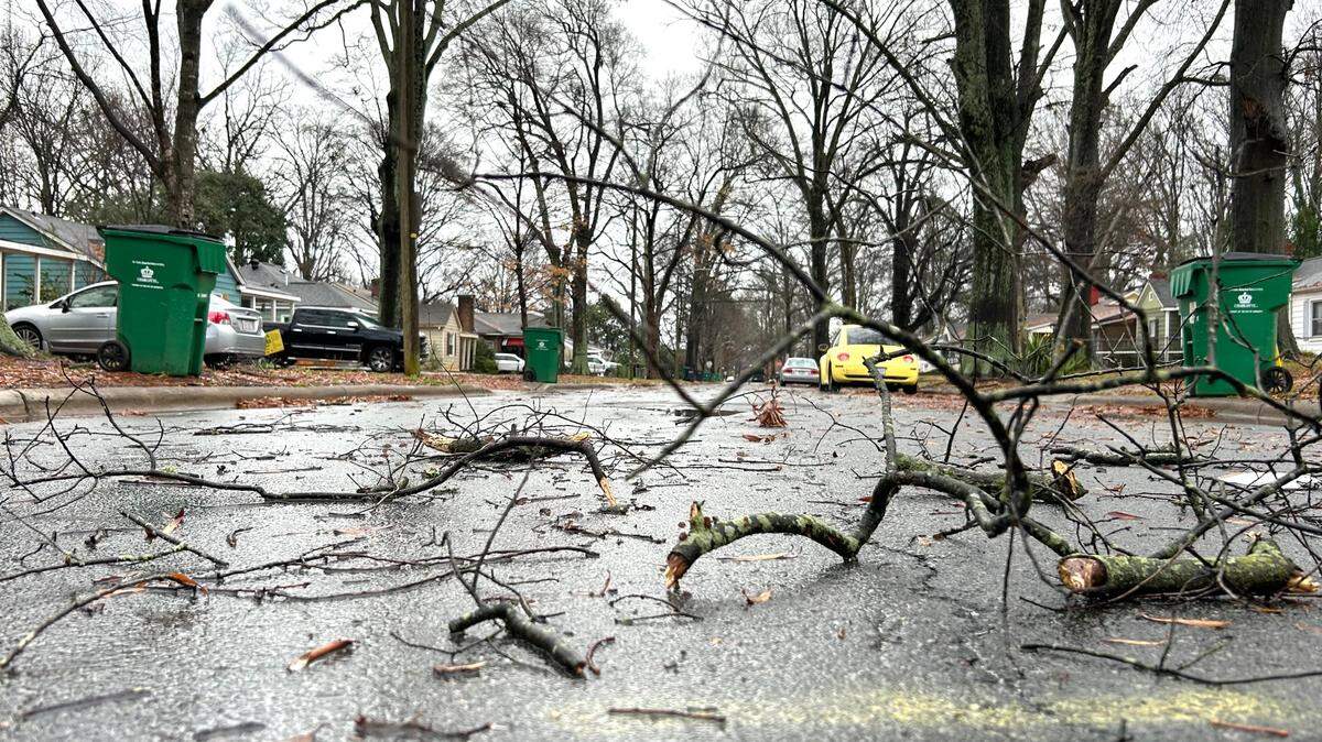 Small tree branches, blown down from the storm earlier this morning, lie strewn over Keswick Avenue in Charlotte, NC on Sunday, December 29, 2024.