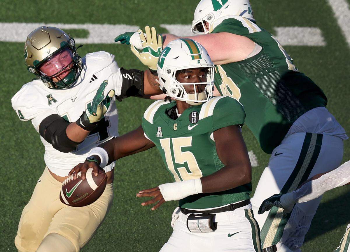 Charlotte 49ers quarterback Deshawn Purdie, center, drops back to pass to a receiver during action against South Florida on Saturday, November 16, 2024 at Jerry Richardson Stadium.