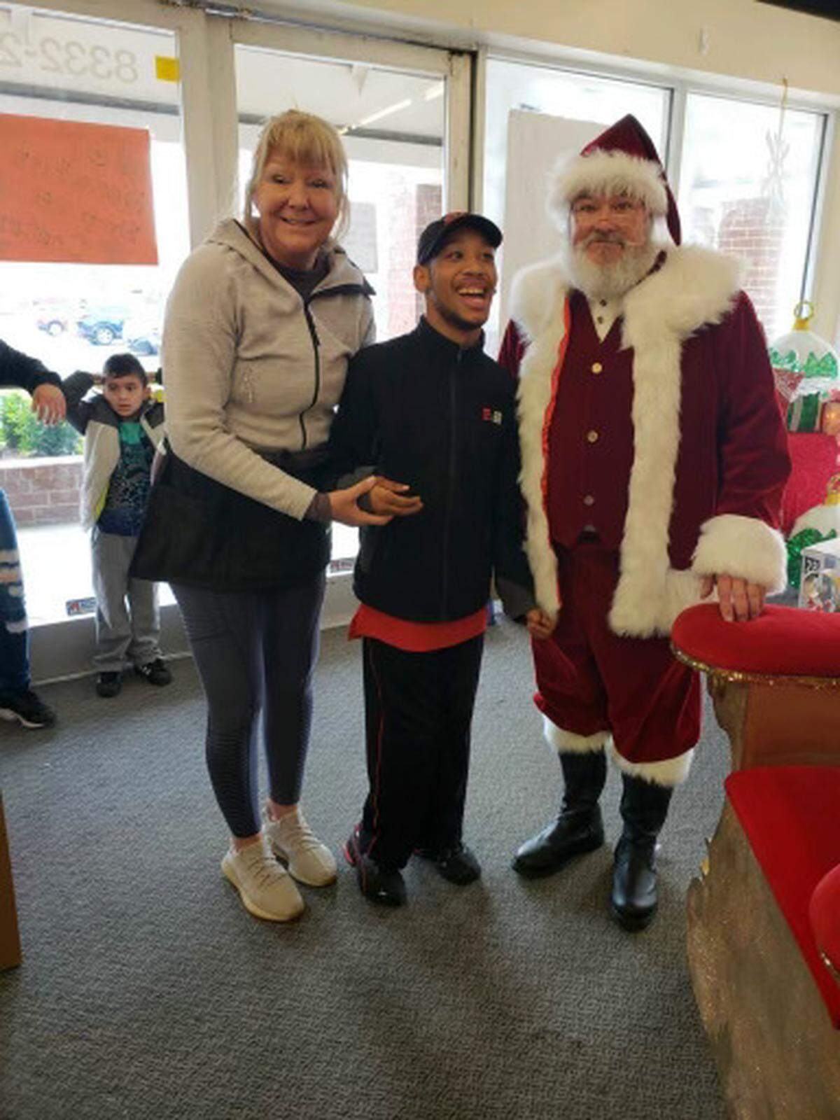 Sharon Sanders with Chancellor Lee Adams and “Santa” at a past Kids First of the Carolinas Christmas event.