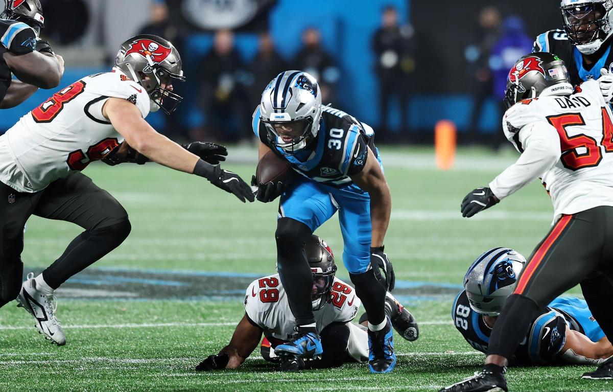 Carolina Panthers running back Chuba Hubbard rushes up the middle during overtime against the Tampa Bay Buccaneers at Bank of America Stadium in Charlotte, NC on Sunday, December 1, 2024. Hubbard would fumble the ball on the play. The Buccaneers defeated the Panthers 26-23.